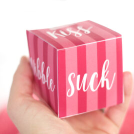 pink sexy dice with the word suck in a hand