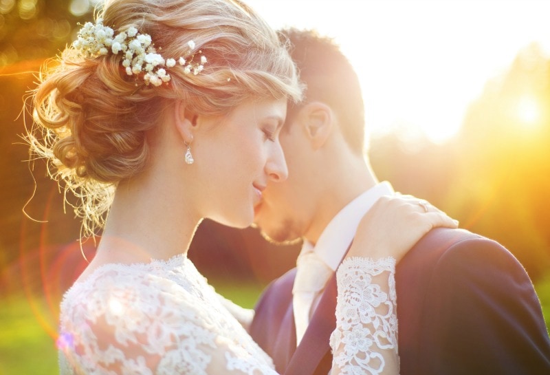 Couple embracing on their wedding day in the sunset