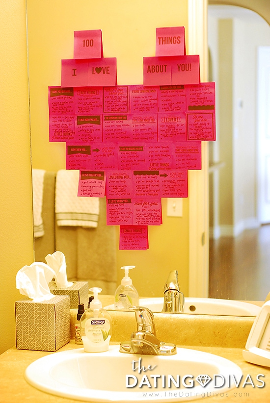 100 things I love about you written on pink sticky notes in the shape of a heart on bathroom mirror