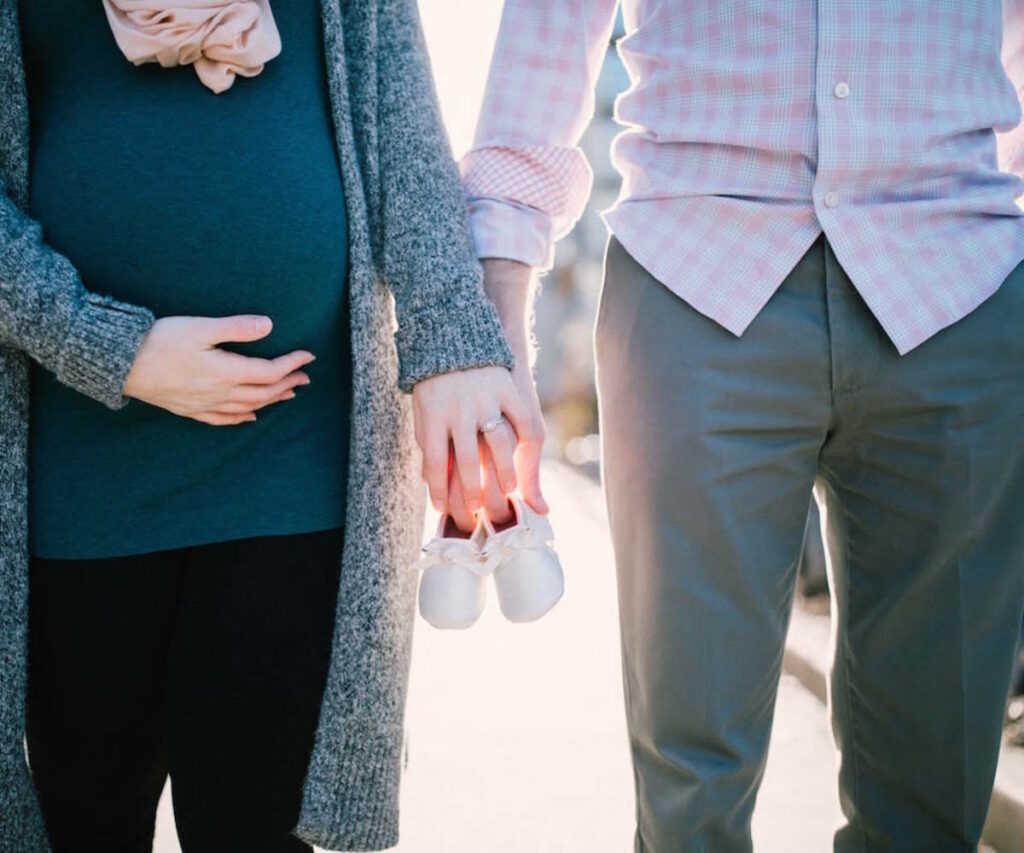 Couple Holding Baby Shoes