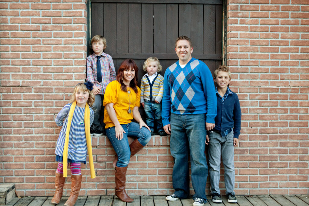 Family on Brick Wall Taking Picture