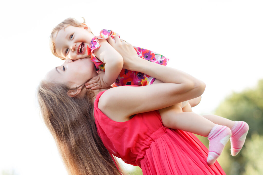 Mother Kissing Baby Girl