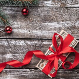 Money for Christmas tied in red bow | The Dating Divas