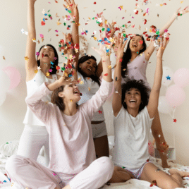 Women celebrating at bridal shower throwing confetti in air | The Dating Divas