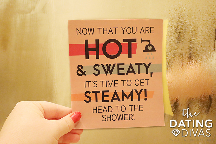 Wife holding Sexercise printable in the steamy shower | The Dating Divas