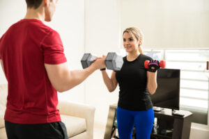 A husband and wife doing bicep curls at home | The Dating Divas