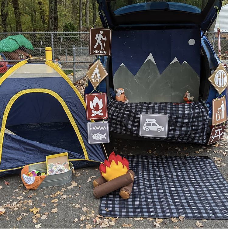 Trunk or Treat decorating with a camping theme - including a camping tent, campfire and mountain range | The Dating Divas