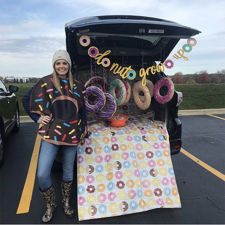 A trunk decorated with a donut blanket and hanging inflatable donuts for a trunk or treat Halloween event. A fun trunk or treat theme. | The Dating Divas