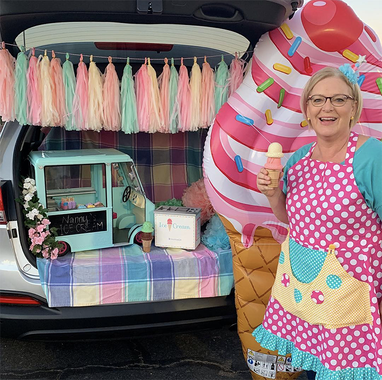 A trunk decorated with a colorful banner and ice cream store decor as part of a trunk or treat Halloween event. A fun Trunk or Treat theme idea. | The Dating Divas