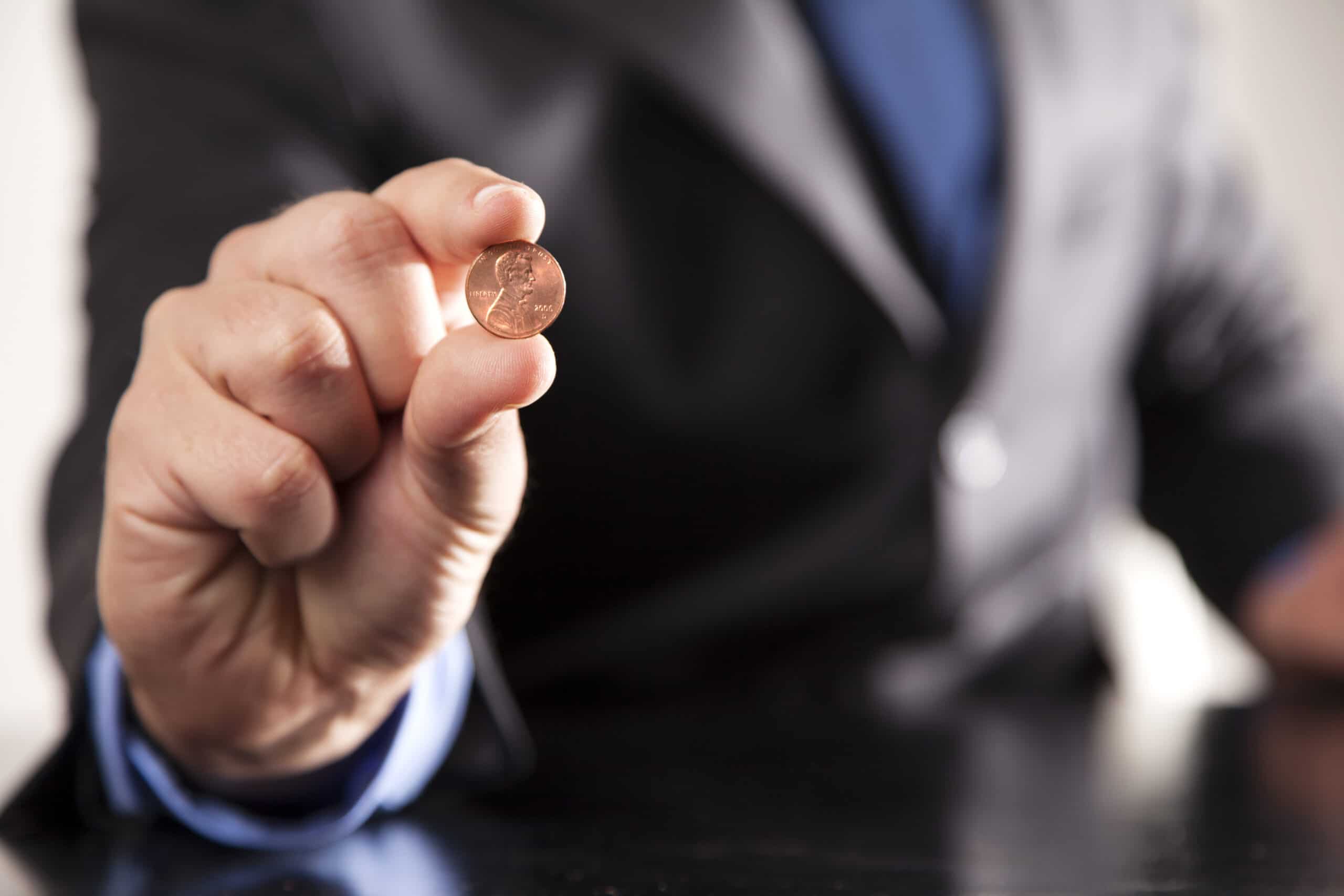 A penny to be used during Minute to Win It challenge - www.thedatingdivas.com A hand holding a penny to be used during Minute to Win It game | The Dating Divas