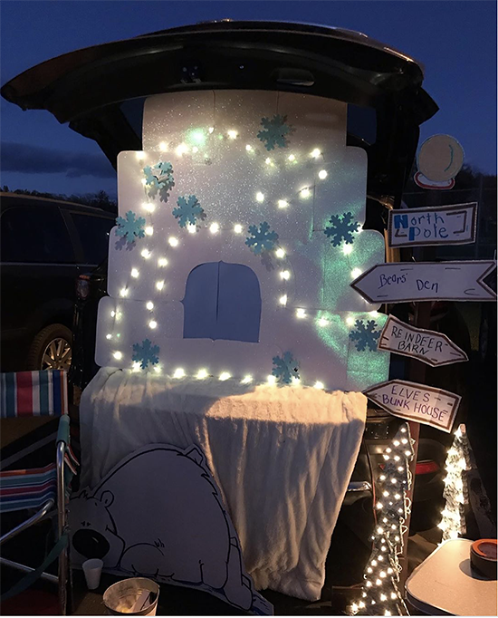 A trunk decorated with snowflakes and Christmas lights as well as signs indicating the directions to the North Pole. A fun trunk or treat theme idea. | The Dating Divas