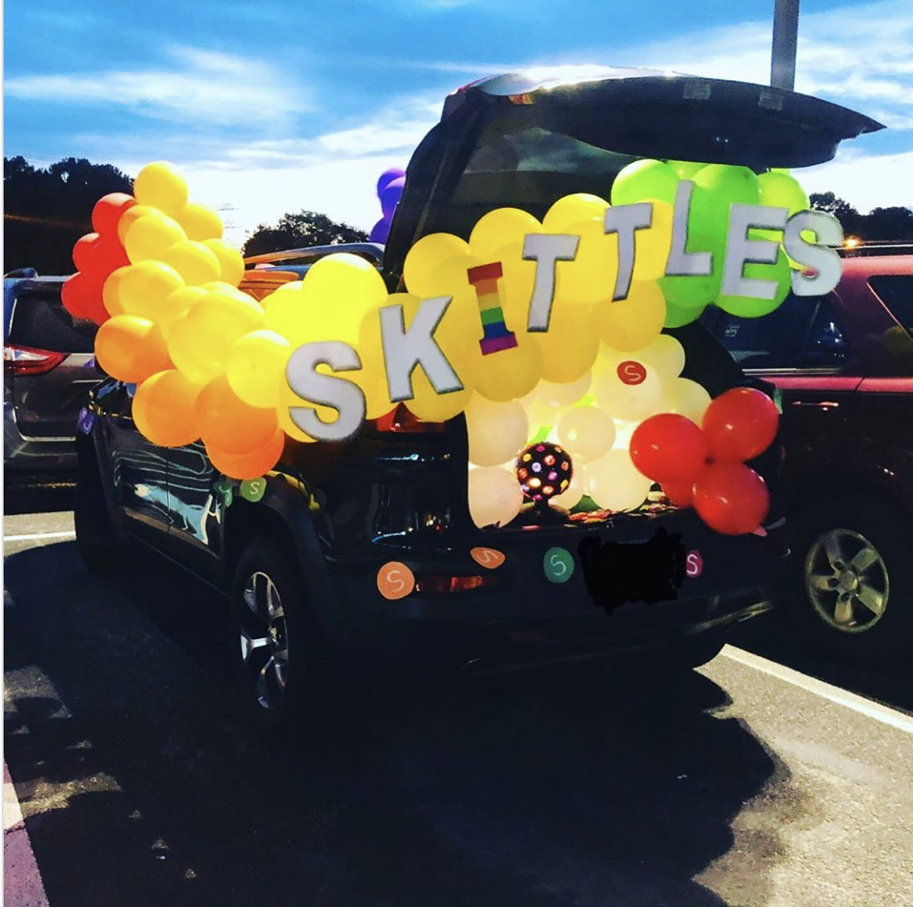 A colorful trunk display using balloons in the colors of skittles candy. Car trunk is decorated for a trunk or treat event |The Dating Divas