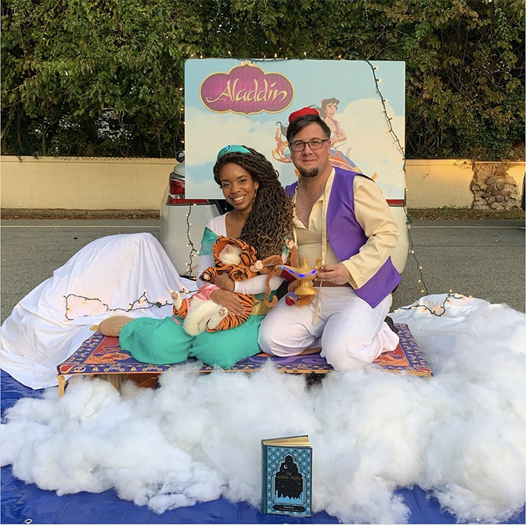 Trunk decorated with fluffy cotton clouds with an Aladdin backdrop and magic carpet - a great trunk or treat idea | The Dating Divas