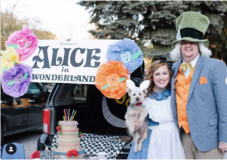 Trunk decorated with an Alice in Wonderland theme including a very unbirthday cake and a large Cheshire cat - a great trunk or treat idea | The Dating Divas