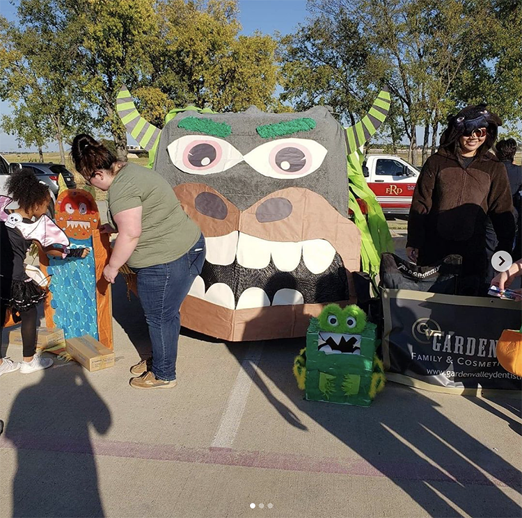 A trunk decorated as a full. To the side is a fun punch activity for kids to pick a prize. A fun interactive trunk or treat idea. | The Dating Divas