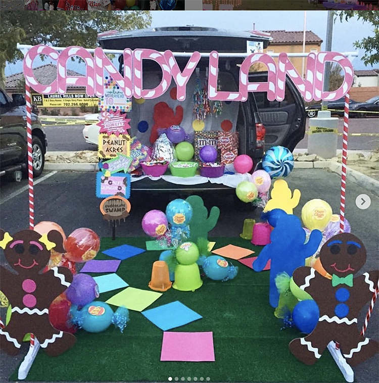 A trunk decorated like the board game, Candyland. A colorful pathway leads to the car's trunk that is filled with oversized candy. A large Candyland sign hangs above the trunk. Candyland is a classic board game that makes a fun theme for a Halloween Trunk or Treat event. | The Dating Divas