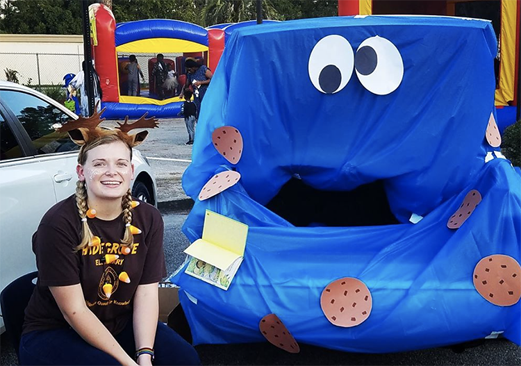 A trunk decorated with a fitted blue sheet to create the character of Cookie Monster from Sesame Street. A super fun trunk or treat idea for Halloween. | The Dating Divas