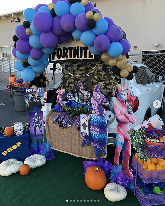 A car trunk decorated for a trunk or treat event using the video game Fortnite. It includes the colors and characters from the video game. | The Dating Divas