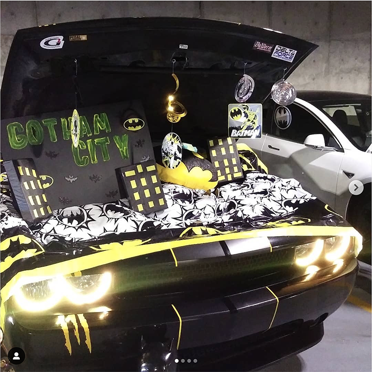 Trunk decorated with a theme for the movie Batman. It includes cut outs in the shape of Gotham city. This is a great trunk or treat idea | The Dating Divas