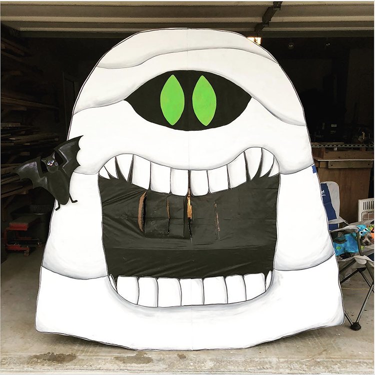 Trunk decorated with a theme for the movie Hotel Transylvania. It includes a large cut out of a mummy character from the show. This is a great trunk or treat idea | The Dating Divas