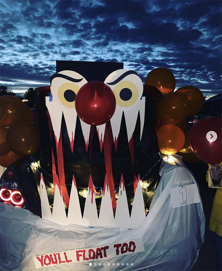 A trunk decorated as the scary clown from Stephen King's book and movie "It". This is a fun idea for a scary trunk or treat theme | The Dating Divas