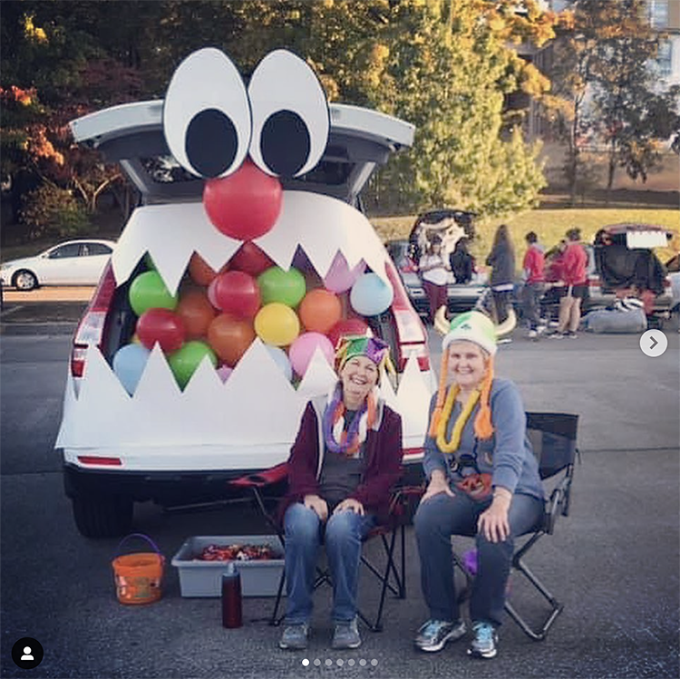 A trunk decorated as a large mouth of a monster. The trunk is filled with balloons giving the look of various colorful candies in the monster's mouth. The trunk is the mouth of the monster. This is a very popular and easy trunk or treat idea. | The Dating Divas