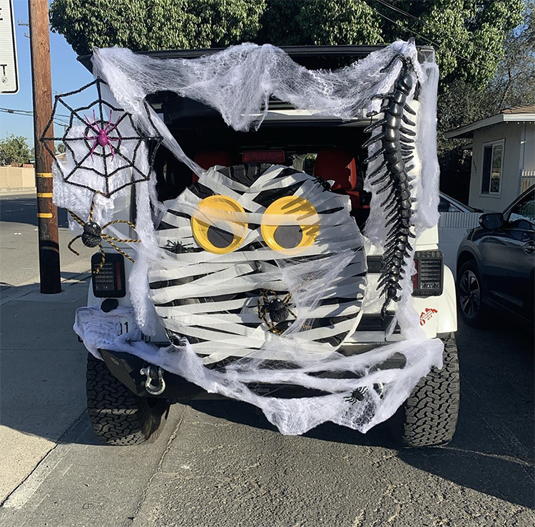 A car trunk decorated for a Halloween trunk or treat as a large mummy. This is a fun idea for a scary trunk or treat theme | The Dating Divas