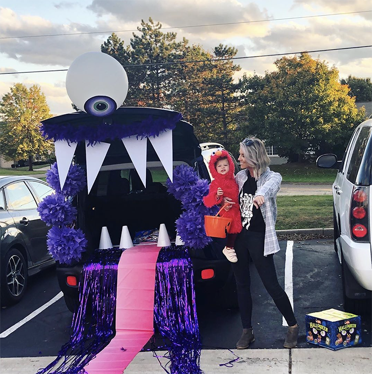 A trunk decorated as a large mouth of a one-eyed monster. The trunk is the mouth of the monster. This is a very popular and easy trunk or treat idea. | The Dating Divas