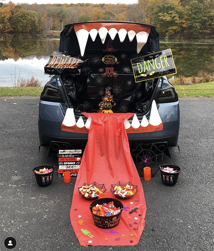 A trunk decorated as a large mouth of a scary monster. The trunk is the mouth of the monster. This is a very popular and easy trunk or treat idea. | The Dating Divas