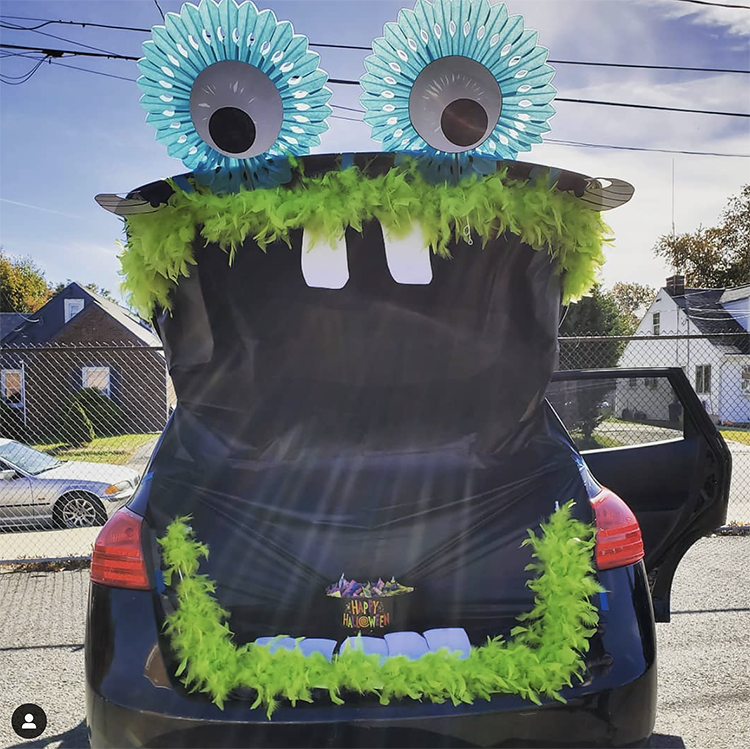 A trunk decorated as a large mouth of a surprised monster. The trunk is the mouth of the monster. This is a very popular and easy trunk or treat idea. | The Dating Divas