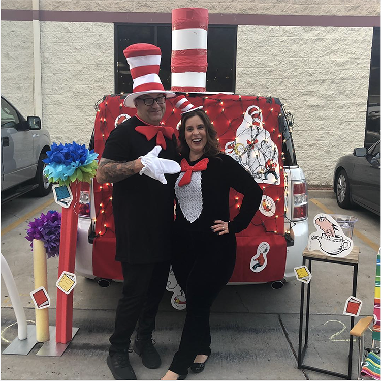 Trunk decorated with a theme for the book, movie and tv show The Cat in the Hat by Dr. Seuss. It includes a couple in Cat in the Hat costumes to coordinate with the theme. This is a great trunk or treat idea | The Dating Divas