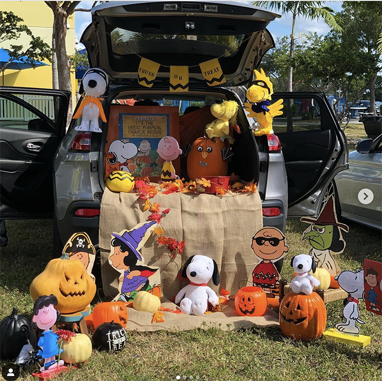 A trunk decorated with the theme of Charlie Brown's Great Pumpkin. There are several Snoopy character cutouts and stuffed animals included Lucy, Charlie Brown and Woodstock. There are also a lot of pumpkins. This is a fun Halloween trunk or treat idea. | The Dating Divas