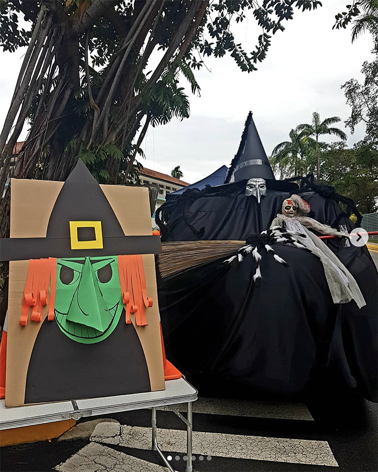 A trunk decorated as a large witch stretching across the bed of a truck. This is a fun idea for a scary trunk or treat theme | The Dating Divas