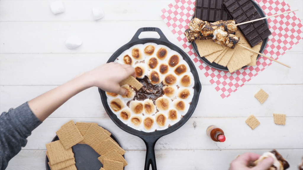 Skillet filled with smores dip for a girls night in | The Dating Divas