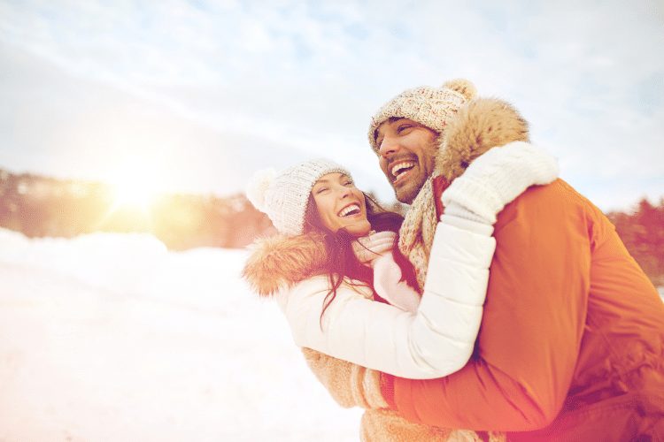Couple outside enjoying snow | The Dating Divas