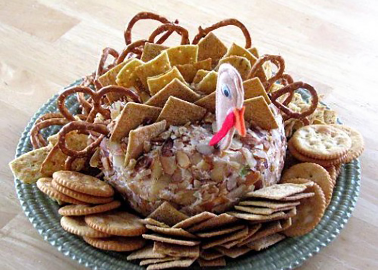 Jazz up your cheeseball with these Thanksgiving food ideas in a turkey shape. | The Dating Divas