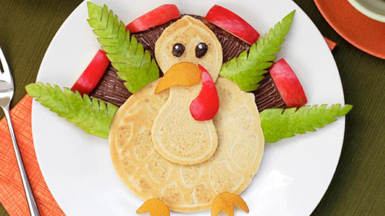 Fruit and pancakes can make an adorable turkey for your Thanksgiving breakfast. | The Dating Divas