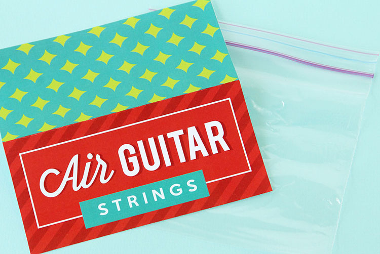 An empty Ziplock bag with a printable labeled "Air Guitar Strings" - an example of cheap white elephant gift ideas | The Dating Divas