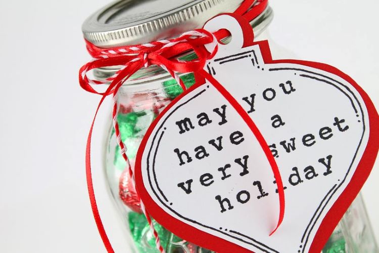 A mason jar that's filled with candy and other sweet Christmas treats | The Dating Divas