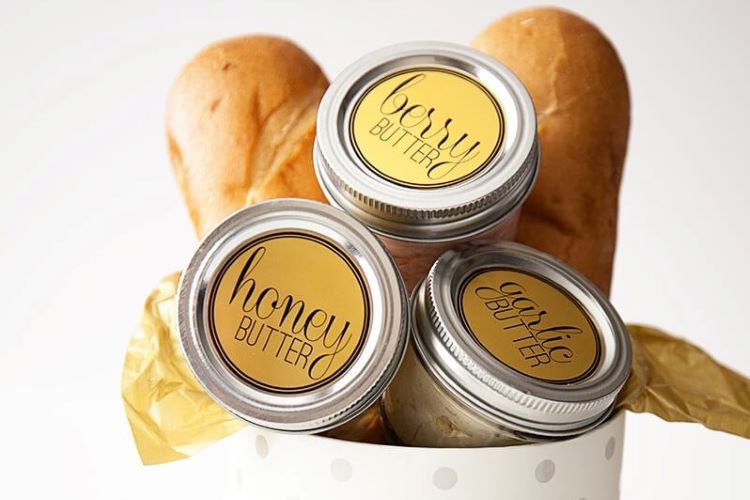 A bread themed gift basket with three jars of flavored butter | The Dating Divas