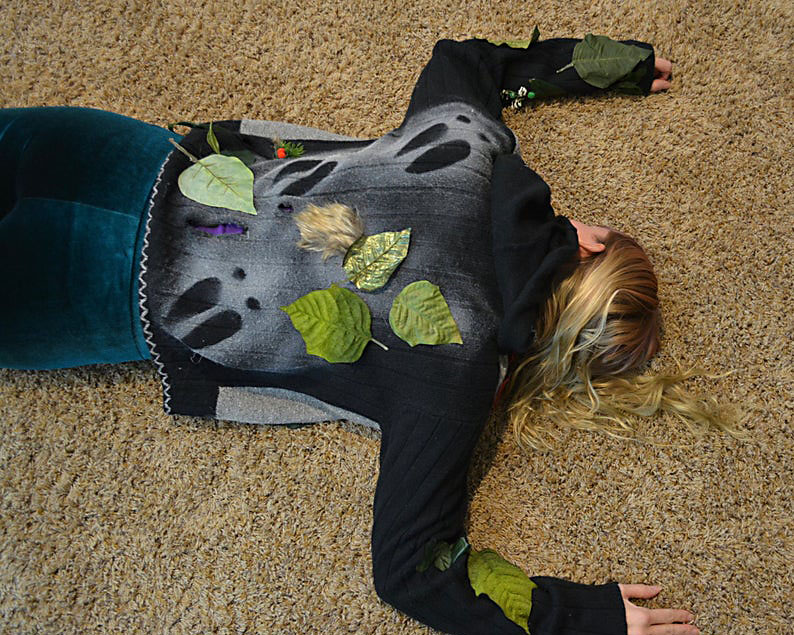 Woman Lays Down with Reindeer Tracks on Her Back for an Ugly Sweater Party | The Dating Divas