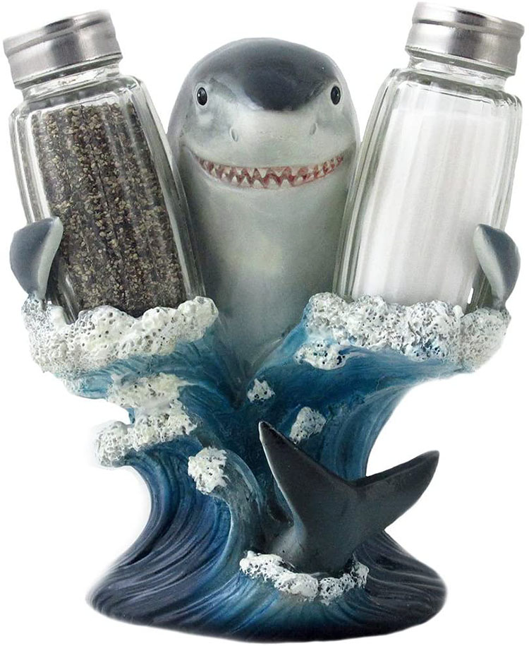 A shark figurine holds up a salt and a pepper shaker - a fun Christmas gag gift idea | The Dating Divas