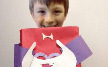 A little boy holding a personalized cereal box made into a Valentine's Day box | The Dating Divas