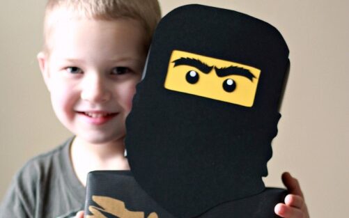 Little boy holding up Lego ninja themed Valentine's Day box | The Dating Divas 