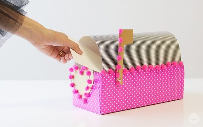 Mini bright pink mailbox turned into a Valentine's Day box for cards | The Dating Divas