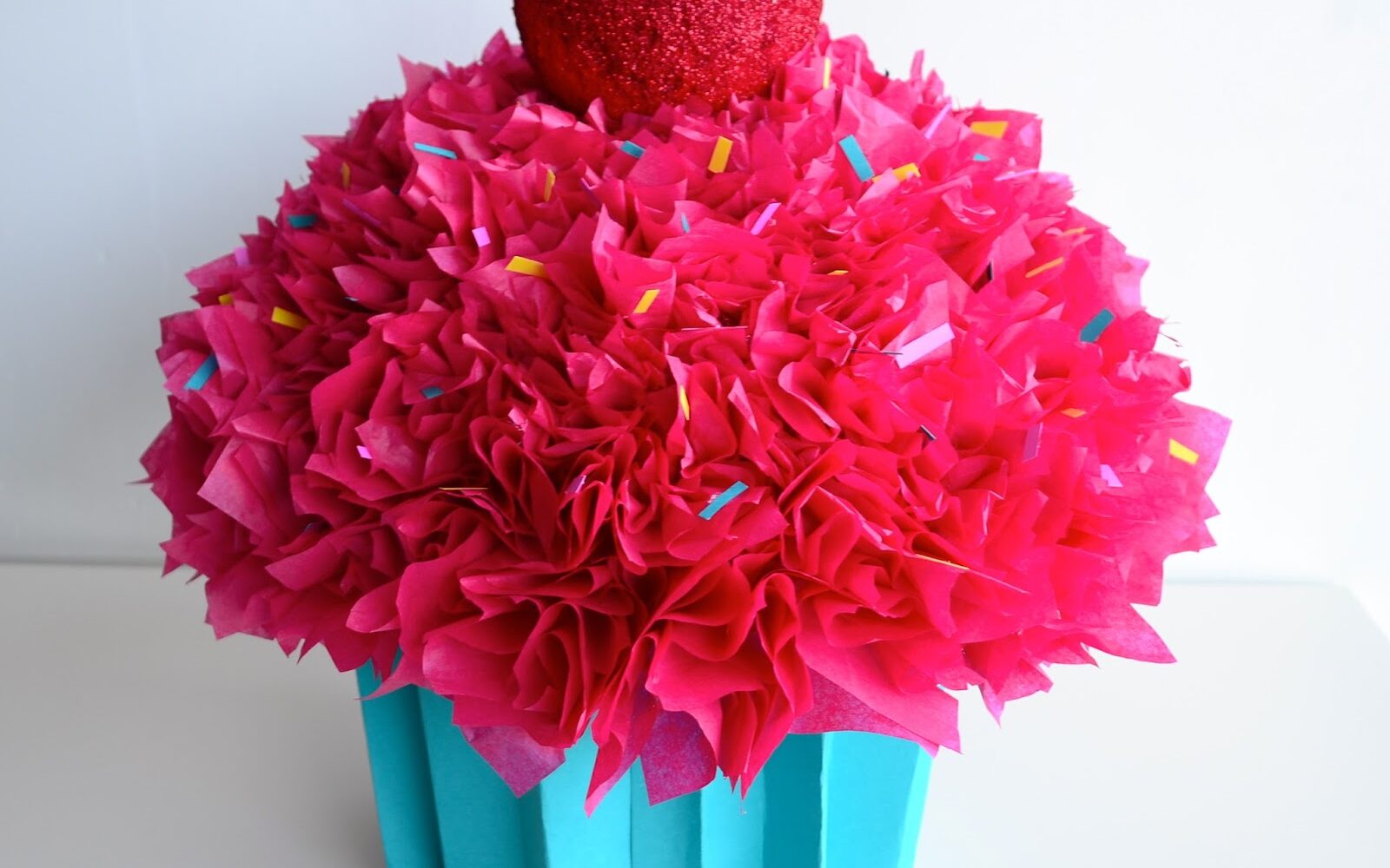 Bright pink Valentine's Day box cupcake with fluffy paper icing | The Dating Divas