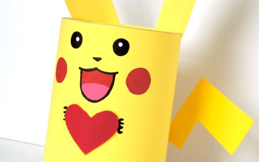 Bright yellow Pikachu valentine box holding a red heart | The Dating Divas