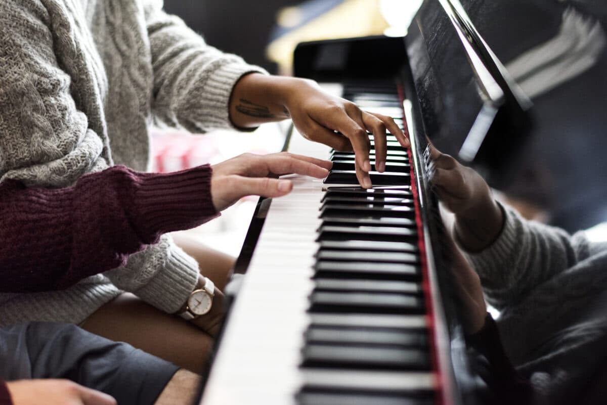 A couple with different beliefs learning to play the piano together. | The Dating Divas