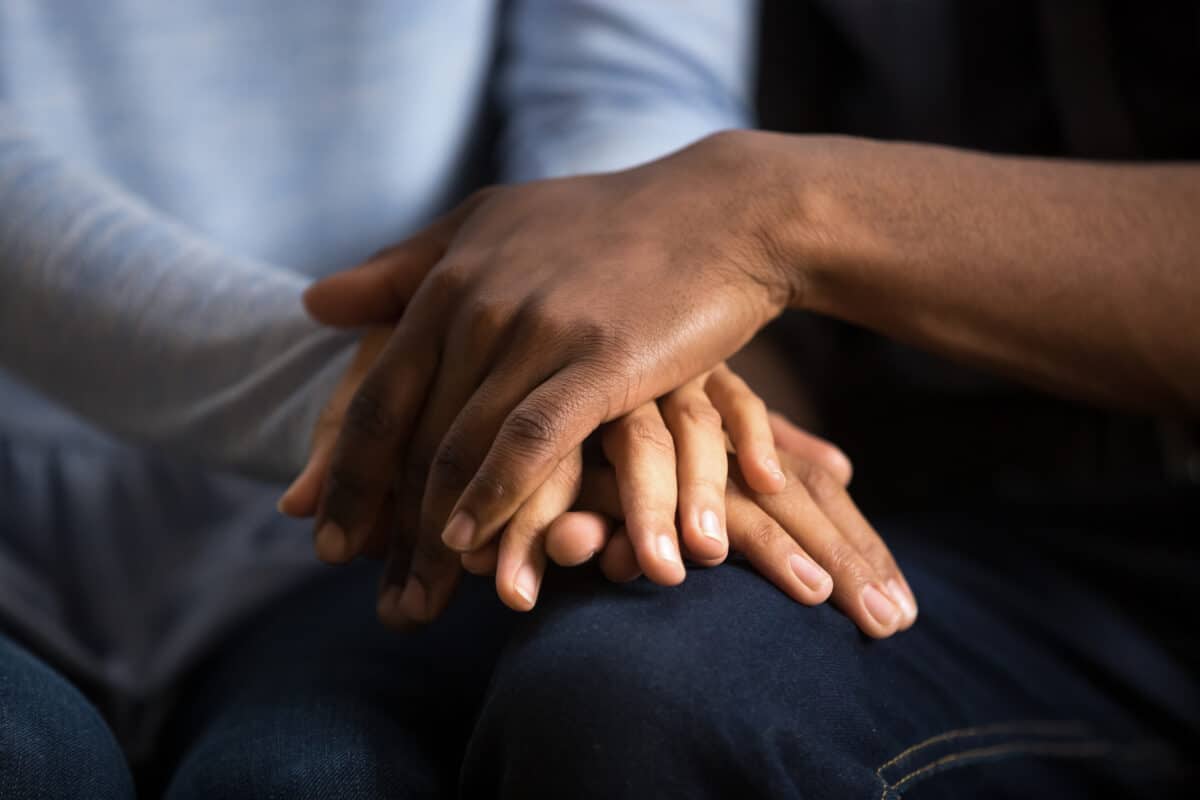 Interfaith couple holding hands and sharing their beliefs | The Dating Divas