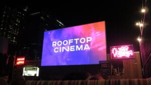 People having fun watching a movie on a rooftop | The Dating Diva